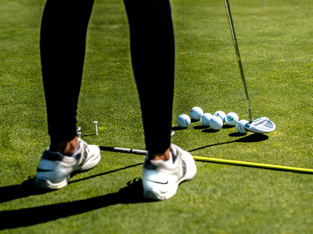 Golfer with golf balls and putter